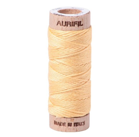 Spool of Aurifil thread on a white background