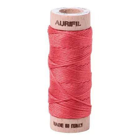 Spool of red thread with 'Aurifil' branding on a white background