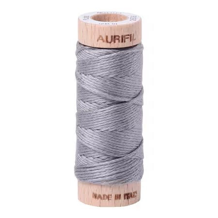 Spool of Aurifil thread on a white background