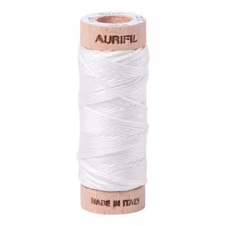 Spool of white thread on a wooden reel with 'Aurifil' branding on a white background