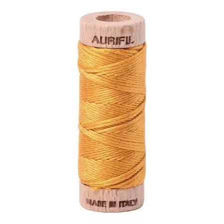 Spool of Aurifil thread on a white background