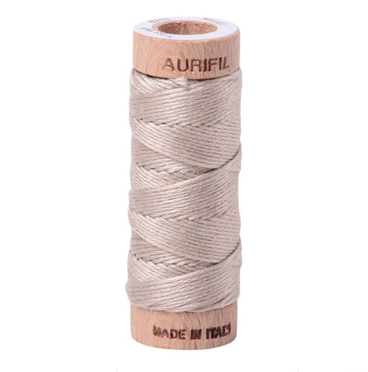 Spool of Aurifil thread on a white background