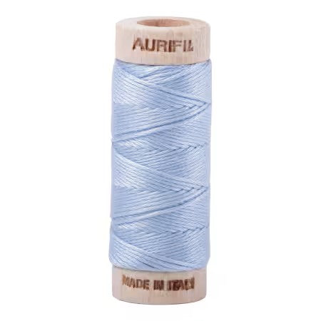 Spool of light blue thread with 'Aurifil' branding on a white background