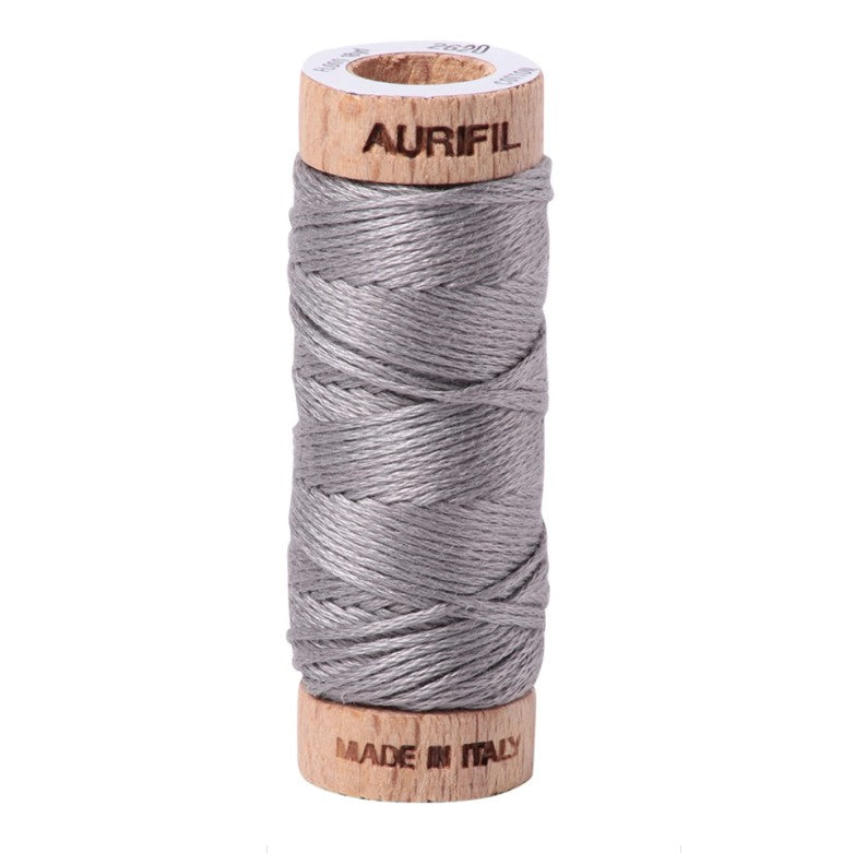 Spool of Aurifil thread on a white background