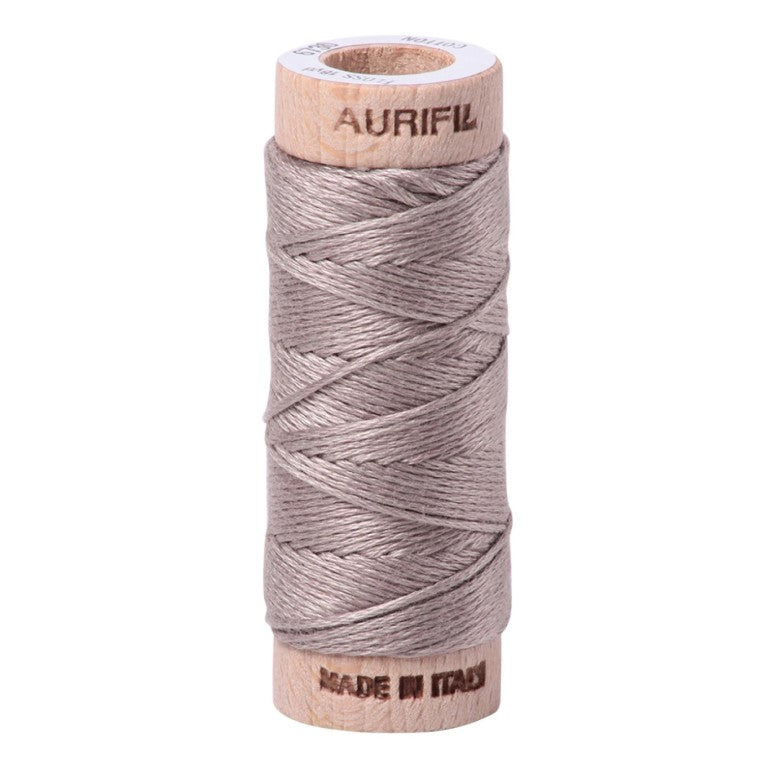 Spool of Aurifil thread on a white background