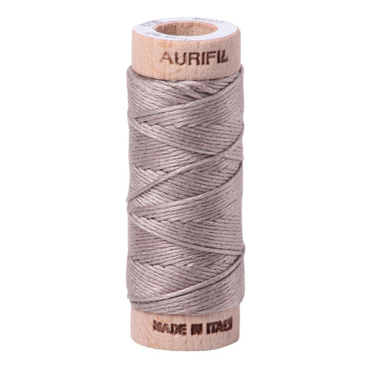 Spool of Aurifil thread on a white background