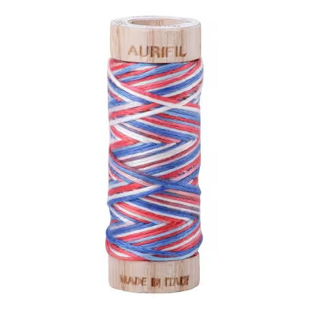 Spool of Aurifil thread with wooden container on a white background