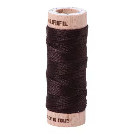 Spool of dark brown thread on a white background