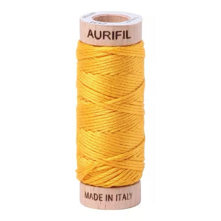 Spool of yellow Aurifil thread on a white background