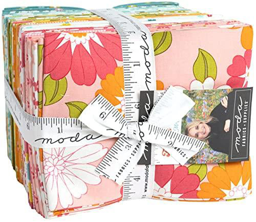 Stack of colorful fabric squares with a measuring tape and Moda label.