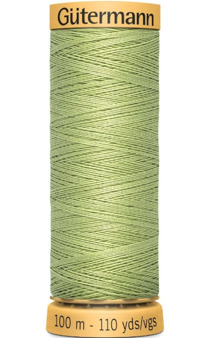 Spool of green thread with 'Gutermann' branding on a white background
