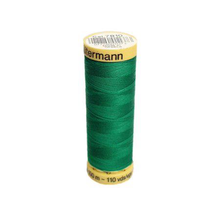 Green spool of Gutermann thread on a white background