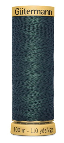 Spool of Gutermann thread in teal color on a white background