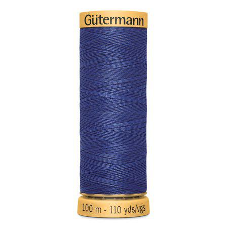 Spool of blue Gutermann thread on a white background