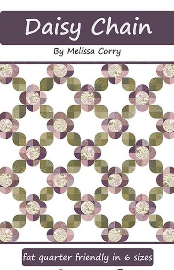 Patterned fabric with 'Daisy Chain' design by Melissa Corry, featuring green and purple flowers on a white background.