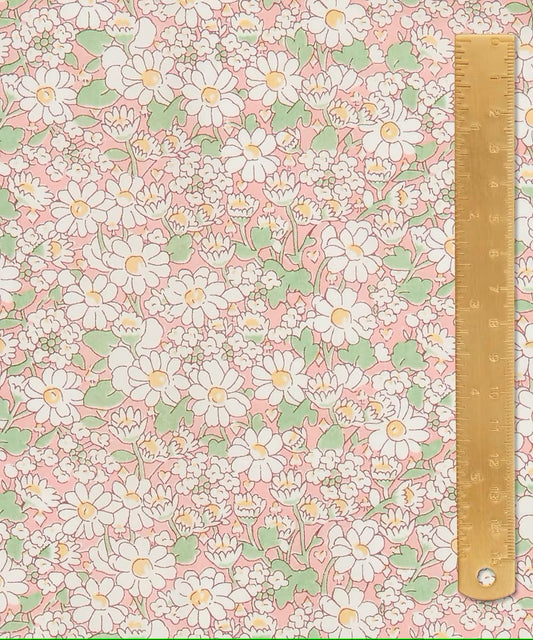 Floral pattern with daisies on a pink background, accompanied by a ruler for scale.