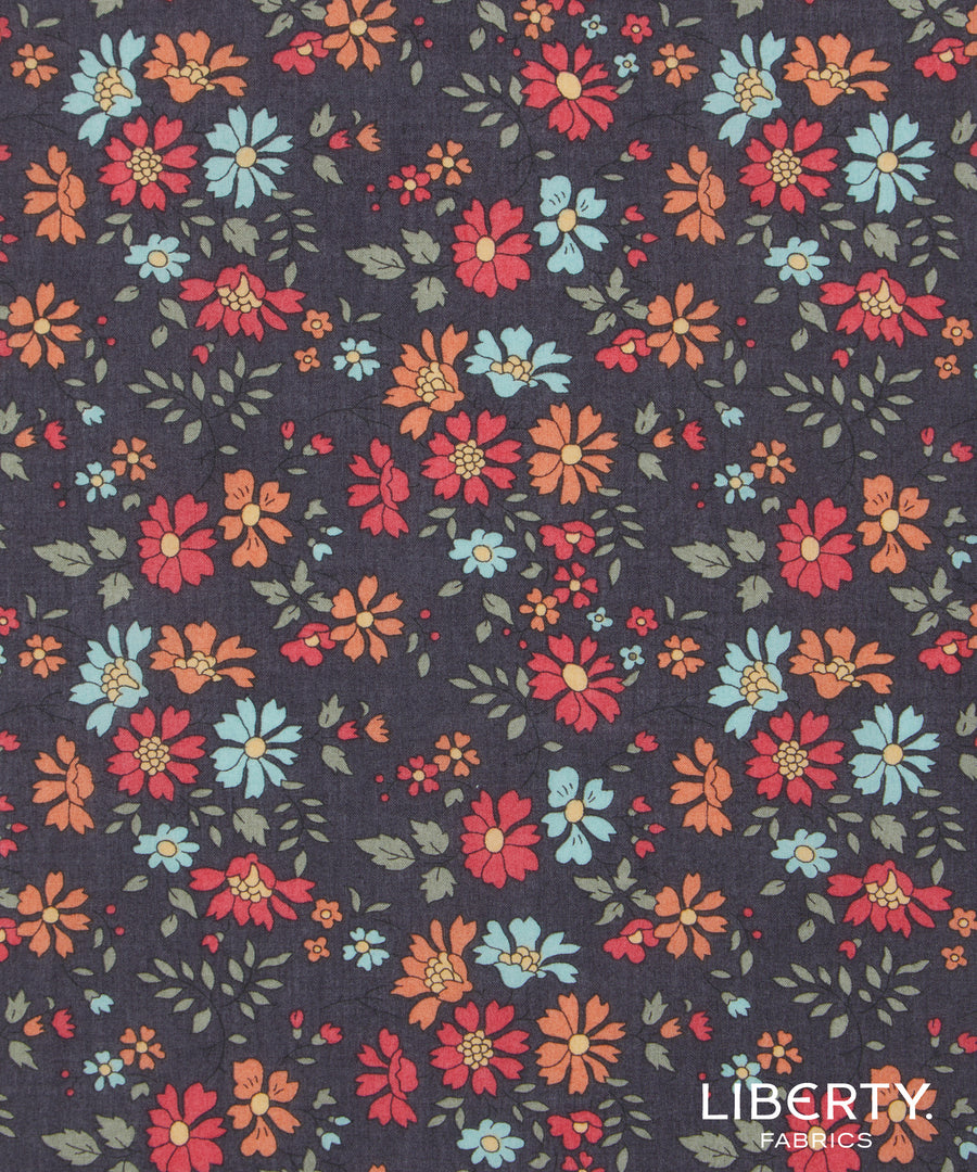 Floral pattern fabric with Liberty Fabrics logo on a dark background