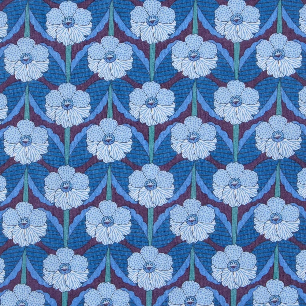Patterned fabric with blue and white floral design on a blue background