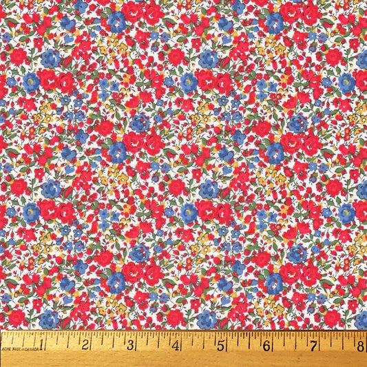 Floral fabric pattern with red, blue, and yellow flowers on a white background, ruler at the bottom for scale.