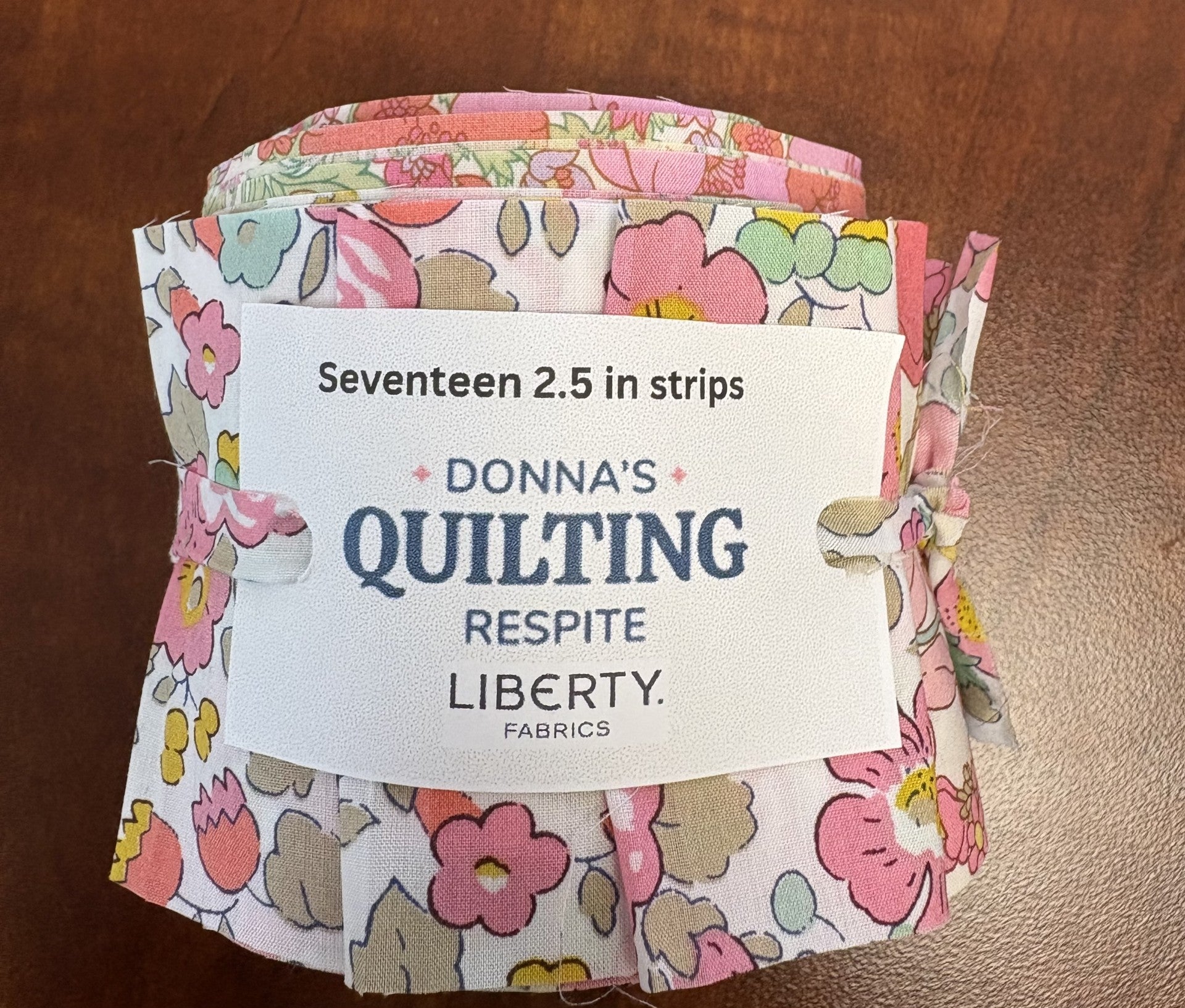 Packaged fabric strips with a label on a wooden surface