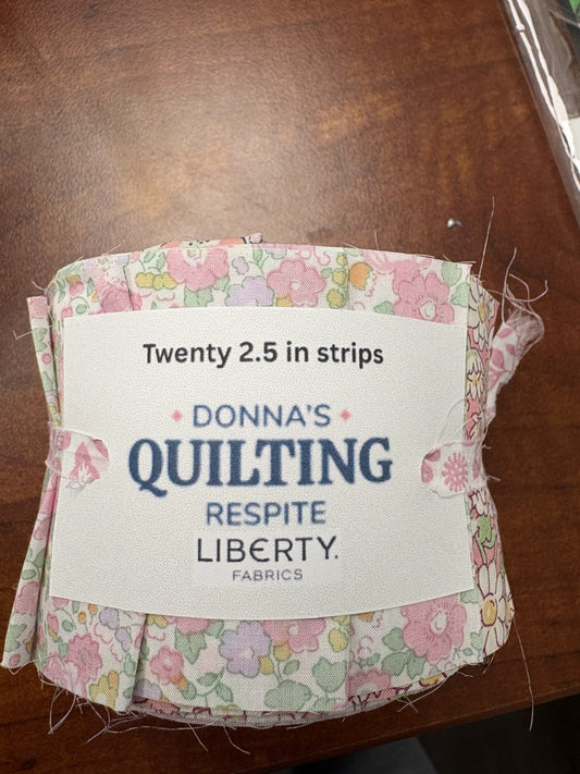 Pack of fabric strips with a label on a wooden surface