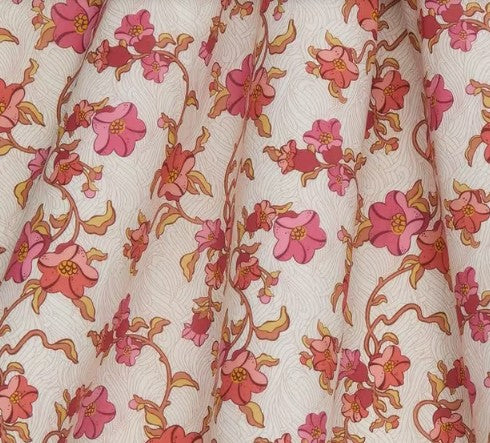Floral patterned fabric with pink flowers and brown leaves on a light background