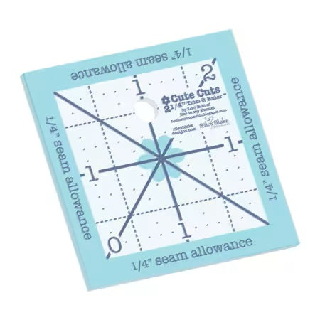 Quilting ruler with grid lines and measurements on a light blue background