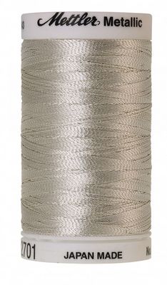 Spool of Mettler metallic thread on a white background