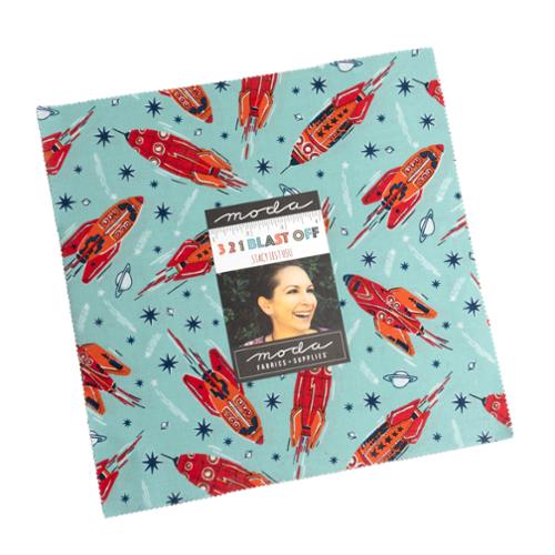 Fabric with rocket ship pattern and Moda label on a white background