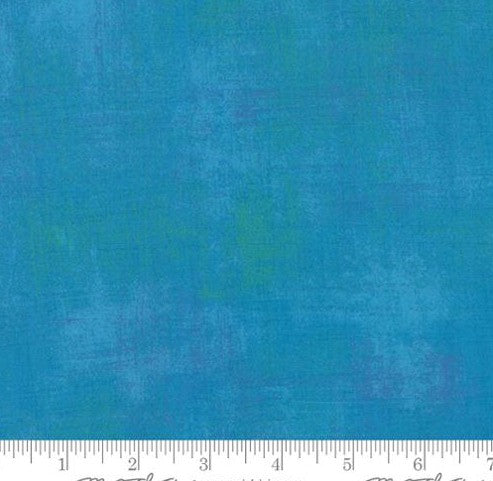 Solid blue fabric swatch with a ruler at the bottom