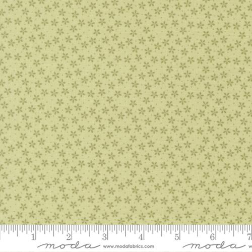 Fabric pattern with small floral design on a light green background, featuring Moda label.