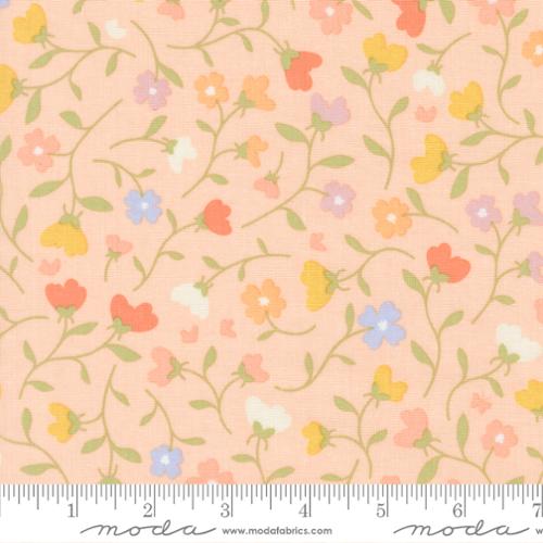 Floral pattern fabric with a ruler at the bottom for scale on a peach background