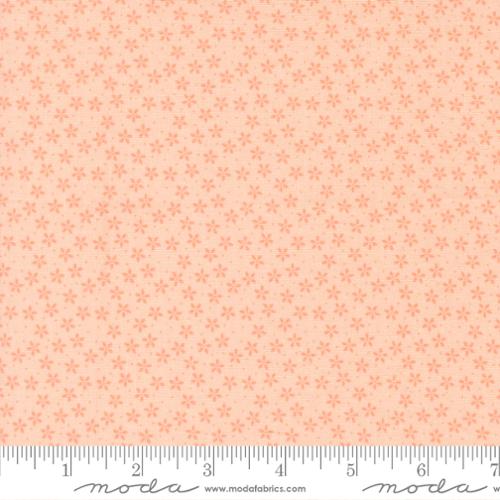 Patterned fabric with small floral design on a light pink background, featuring Moda label.