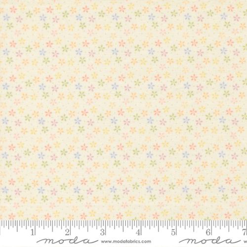 Floral pattern fabric with a ruler at the bottom for scale, on a beige background.