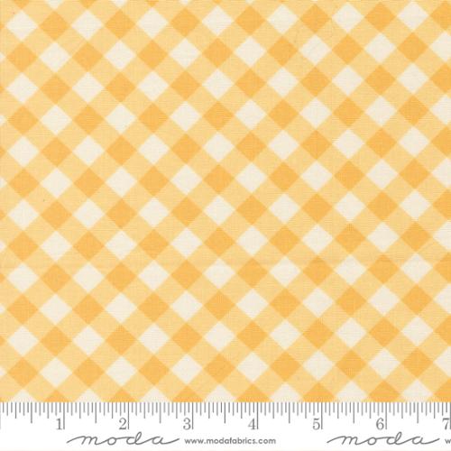 Yellow and white checkered fabric with a ruler at the bottom