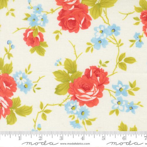 Floral fabric pattern with red roses and blue flowers on a white background, featuring Moda label.