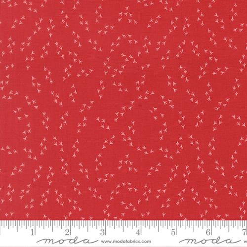 Red fabric with small white floral pattern and Moda label at the bottom.