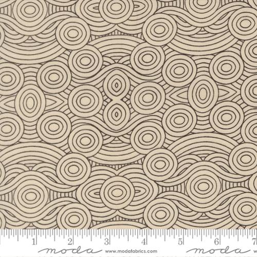 Patterned fabric with circular shapes and a ruler for scale, featuring the brand 'Moda'.