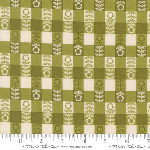 Fabric pattern with green and beige checkered design featuring floral elements, branded 'Moda Fabrics'.