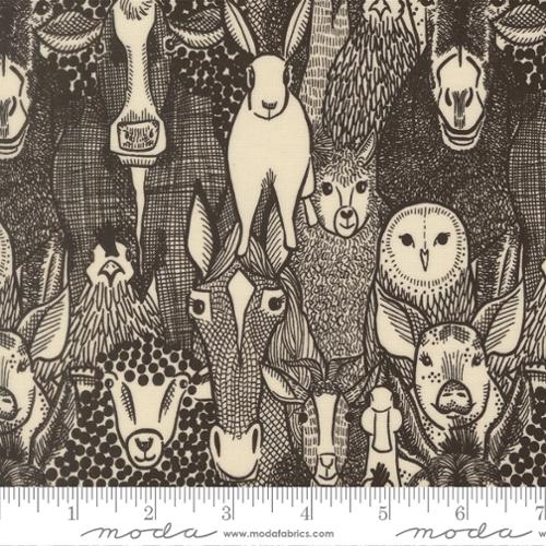 Fabric with black and white animal pattern, featuring sheep and goats, with a Moda label at the bottom.