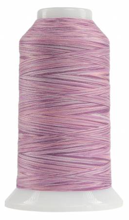 Spool of pink thread on a white background