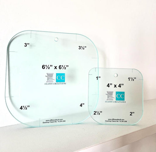 Two clear acrylic rulers with measurement markings on a white background