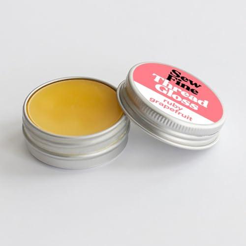 Two tins of Sew Fine Thread Gloss on a white background