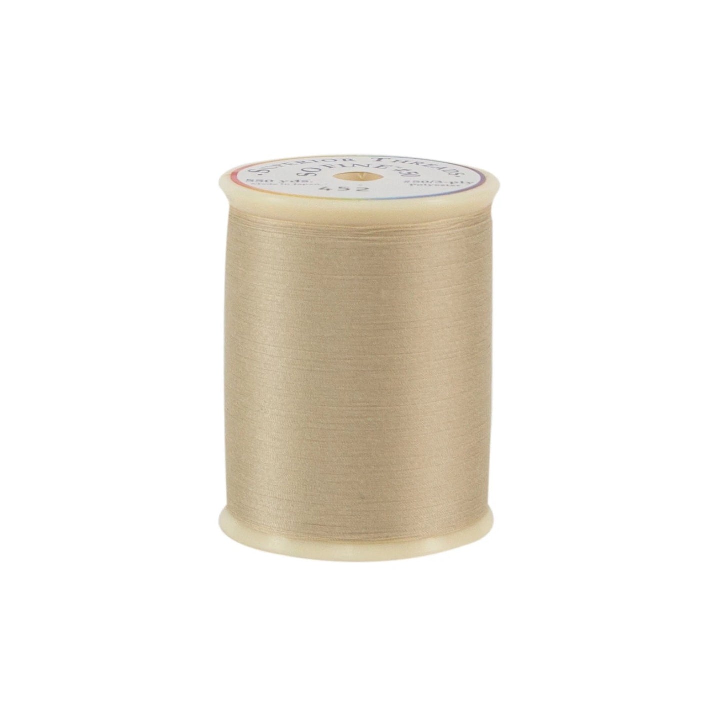 Spool of beige thread on a white background