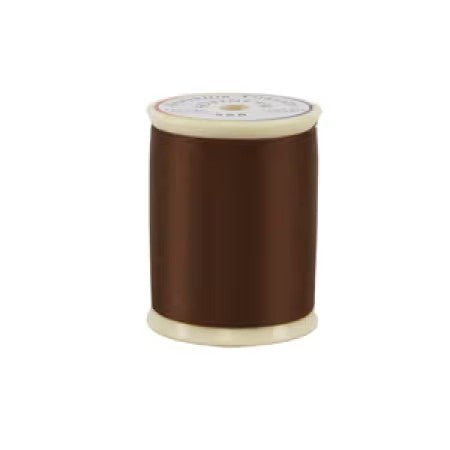 Spool of brown thread on a white background