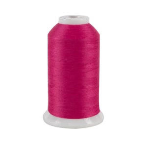Spool of pink thread on a white background