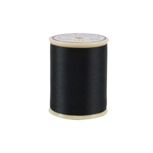 Spool of black thread on a white background