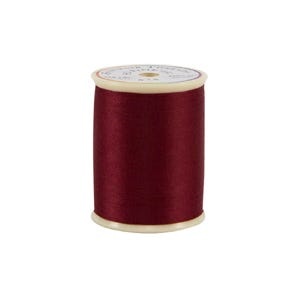 Spool of red thread on a white background
