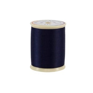 Spool of dark blue thread on a white background