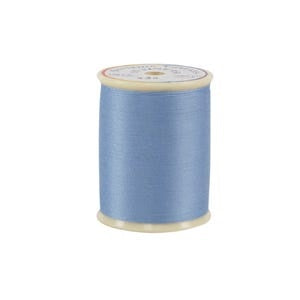 Spool of blue thread on a white background